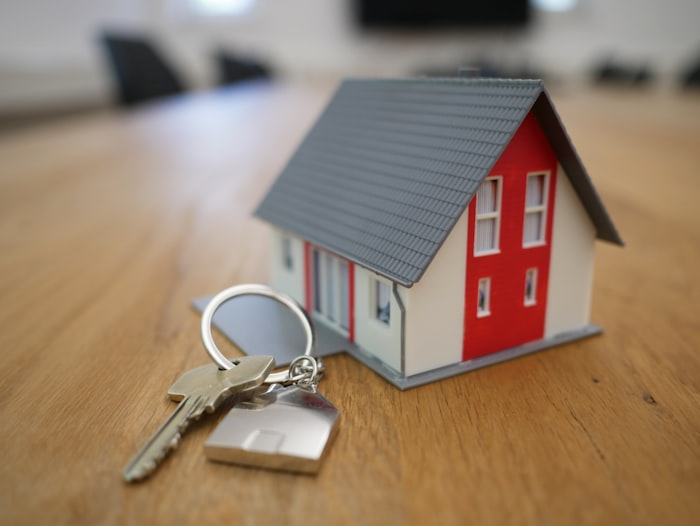 House keys next to a model home — property management